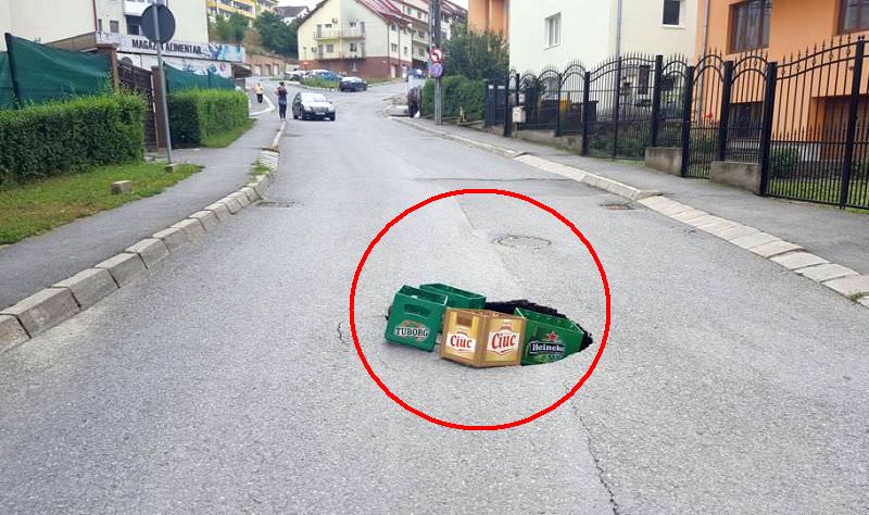 foto – groapă astupată cu lăzi de bere pe islazului la sibiu